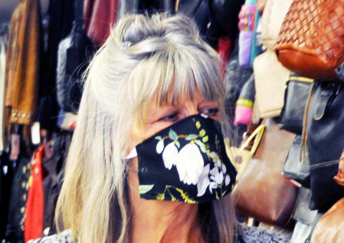 Leather Accents owner Linda Longwell wears face mask